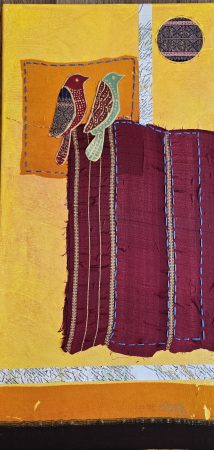 Two colorful birds perched on a purple textile with yellow background.